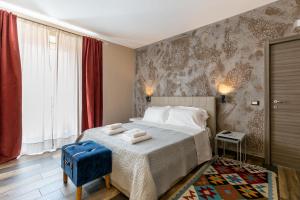 a bedroom with a large bed and a blue chair at Sant'Alfonso in Agrigento