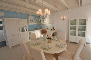 a dining room with a white table and chairs at Villa Opatija Hills in Matulji