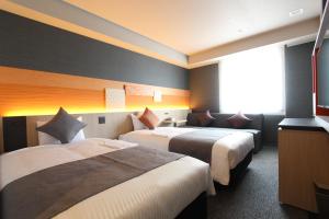 Postel nebo postele na pokoji v ubytování KOKO HOTEL Tsukiji Ginza