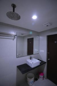 a bathroom with a sink and a mirror at Hotel Marygold in Agra