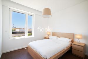 Кровать или кровати в номере Alto da Barra 186E - Parking & Sea View