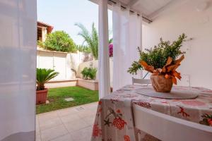 a room with a table with a vase of flowers on it at Casa Nostra in Pula