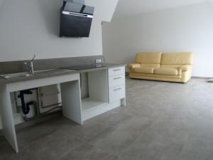 a living room with a sink and a couch at Chez Marcel Gite PMR in La Marne
