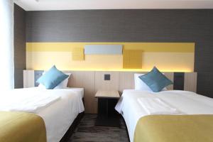 Postel nebo postele na pokoji v ubytování KOKO HOTEL Tsukiji Ginza