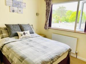 a bedroom with a bed and a large window at Stiles of Ambleside in Ambleside