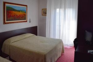 Postel nebo postele na pokoji v ubytování Hotel Igea Spiaggia