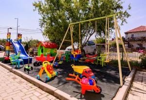 a playground with colorful play equipment in a park at Vilele violeta in Mamaia Sat/Năvodari