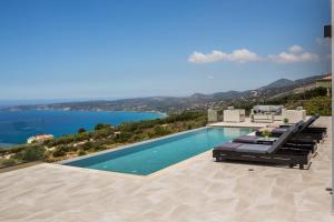 a swimming pool with a view of the water at Panorama Blue Kefalonia - Luxury villa in Lourdata in Simotáta