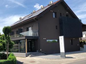 a black building with a sign in front of it at Aparthotel Vital - Vital Resort in Moravske Toplice