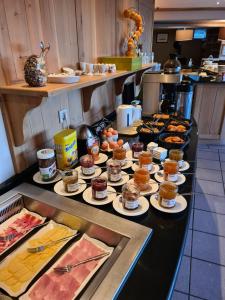 a buffet line with many different types of pastries at Bastide du Cantal in Salers
