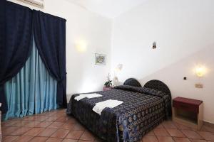 Cama ou camas em um quarto em Hotel Residence S.Angelo