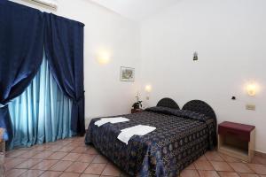 Cama ou camas em um quarto em Hotel Residence S.Angelo