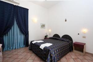 Cama ou camas em um quarto em Hotel Residence S.Angelo