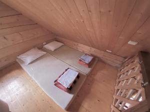 an overhead view of a cabin with two beds and a ladder at Merkiokrantas Trobelė ant upės kranto in Puvočiai