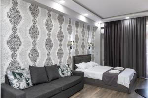 a hotel room with a bed and a couch at Golden Room Apartments 04 in Tbilisi City