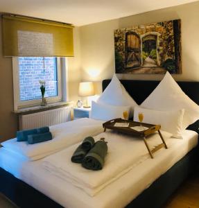 a bedroom with a large white bed with a tray on it at Ferienwohnung C im Ferienhaus Antika in Ratzeburg