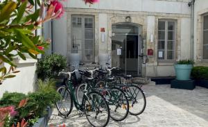a group of bikes parked in front of a building at Hôtel François 1er in La Rochelle