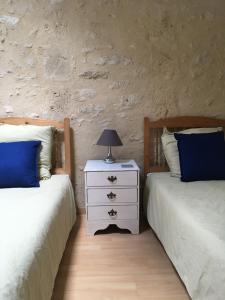 Un pat sau paturi într-o cameră la L'Olivier