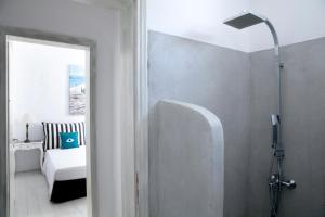 a bathroom with a shower and a room with a bed at Alfa Luxury Villas in Chrissi Akti