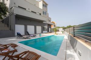 a swimming pool in the backyard of a house at Atena Zaton 2 in Nin