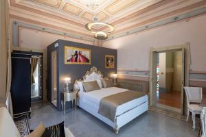 a bedroom with a large bed and a ceiling at Luxury Liberty House - VILLA & SPA in Alghero