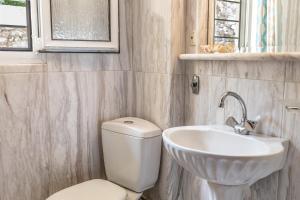 a bathroom with a toilet and a sink at BIG BLUE in Rafina
