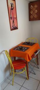 a table and chairs with an orange cloth on it at HeuReka Apartman in Pécs