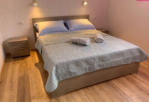 a bedroom with a bed with two towels on it at Apartment Lea Mataija in Novi Vinodolski