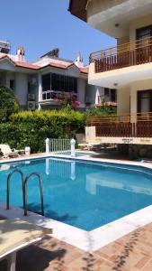 a large swimming pool in front of a building at Üstün Apart in Marmaris