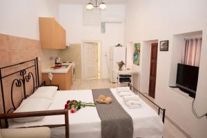 a kitchen and a dining room with a table in a room at Sophia Areopoli Guesthouse in Areopoli