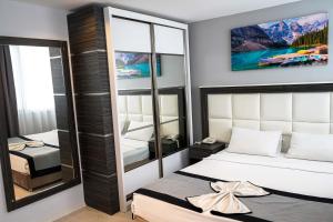 a bedroom with a bed and a mirror at Pasaport Pier Hotel in İzmir