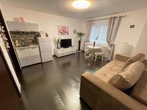 a living room with a couch and a table at Apartament Mihaela in Mamaia