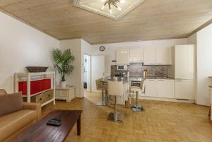 a living room and kitchen with a couch and a table at Easyapartments Altstadt 1 in Salzburg