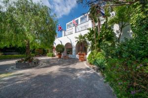 a large white building with flags on top of it at Hotel Villa Durrueli Resort & Spa in Ischia