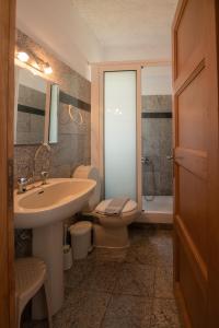 a bathroom with a sink and a toilet and a shower at Arion Hotel in Kolymvari