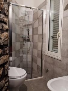 a bathroom with a shower and a toilet and a sink at ngopp a via nova in Agropoli