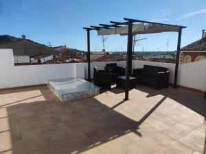 a patio with a canopy on top of a roof at Casa Escalada Palma de Gandia in Palma de Gandía