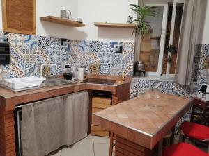a kitchen with a sink and a counter top at ngopp a via nova in Agropoli +7 photos