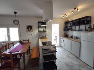 a kitchen with a table and a dining room at Casa Escalada Palma de Gandia in Palma de Gandía