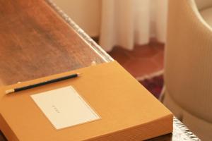 a box with a pen on top of a table at Hotel la Ponche in Saint-Tropez