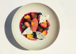 a plate of food with fruits and vegetables on it at Hotel la Ponche in Saint-Tropez