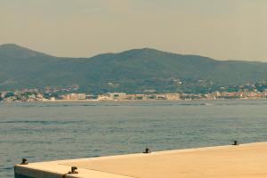 a body of water with mountains in the background at Hotel la Ponche in Saint-Tropez