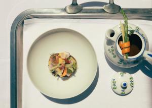 a plate of food and a cup of coffee on a tray at Hotel la Ponche in Saint-Tropez