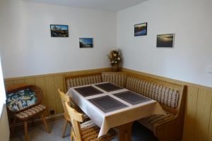 a dining room with a table and chairs and pictures on the wall at Ferienhaus Schaffrath in Ehrenberg