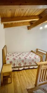 a bedroom with a bed and a wooden floor at Pirin Golf Hotel Private Apartments Апартаменти Планински Изгрев в Пирин Голф in Razlog