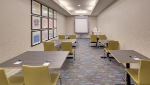 a classroom with tables and chairs and a whiteboard at Holiday Inn Express & Suites Dinuba West by IHG in Dinuba +35 photos