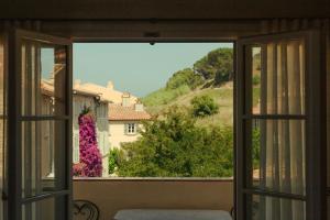an open window with a view of a mountain at Hotel la Ponche in Saint-Tropez