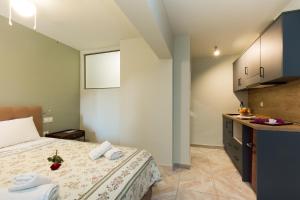 a hotel room with a bed and a kitchen at Limonero New City Apartment 2 with Private Parking in Lefkada Town