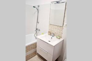 a bathroom with a sink and a mirror at Dream Apartment+parcare gratuita in Oradea