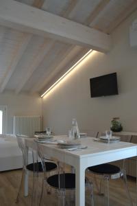 comedor con mesa blanca y sillas en Garda Lake Maison d'Isabella, en Lonato